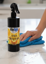 Person cleaning a marble countertop with a bottle of wipe right cleaner.