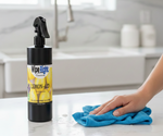 Wipe Right Lemon-Aid multi-purpose cleaner bottle on a kitchen counter with a hand using a blue cloth.